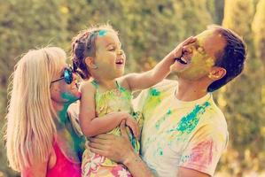 famille souriante heureuse en peinture holi photo