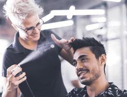 coiffeur professionnel coupe les cheveux des hommes dans un salon de beauté.