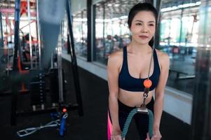 gros plan belle sportive asiatique porter un soutien-gorge de sport sur le mur de la salle de gym, la thaïlande aime la santé, le concept d'entraînement de femme mince