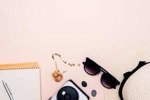 accessoires de voyage d'été. appareil photo, chapeau, lunettes et vue de dessus sur fond clair. avec un espace pour votre texte photo