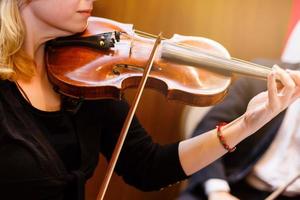 la main de la jeune fille jouant du violon dans des couleurs sombres photo