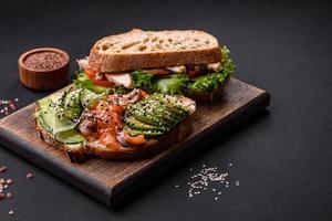 sandwich frais et savoureux au saumon, avocat et graines de sésame et de lin photo