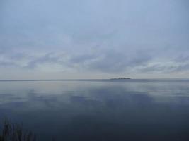 vue sur l'île à l'horizon temps d'automne sombre, paysage marin photo