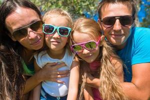 portrait d'une belle famille de quatre personnes en vacances tropicales photo