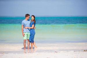jeune couple heureux sur la plage blanche pendant les vacances d'été photo