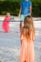 famille heureuse jouant au volley-ball sur la plage avec ballon photo