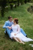 mariée en robe de mariée légère au marié en costume bleu photo