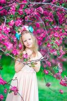 jolie fille dans un jardin de pommiers en fleurs profitez de la chaude journée photo