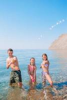 petite fille et papa heureux s'amusant pendant les vacances à la plage photo