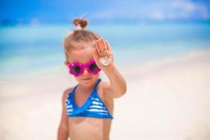 gros plan du sourire fait par la crème solaire sur la paume de la petite fille photo