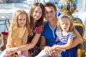 portrait charmante belle famille de quatre personnes au restaurant photo