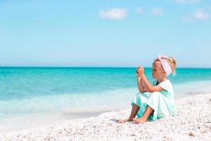 petite fille adorable jouant sur la plage avec ballon photo