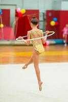 belle petite fille gymnaste active avec sa performance sur le tapis photo