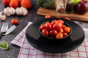 Tomates mûres fraîches sur un chiffon à carreaux rouge photo