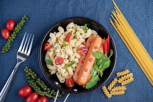 macaroni frit et saucisse dans une poêle photo