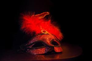 masque de symbole de carnaval de couleur rouge doré avec des plumes photo