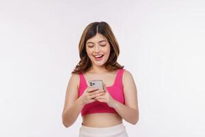 Portrait of young woman using mobile phone isolated over white background photo