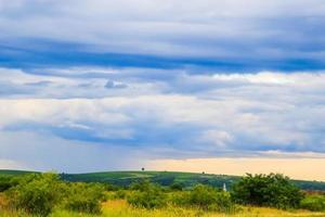 paysage de champ vert avec ciel bleu et nuages orageux. photo