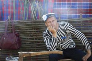biélorussie, village d'aftyuki, 31 juillet 2022. vacances d'humour. homme drôle dans un gilet avec une hache. photo