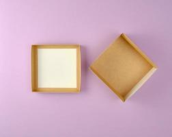 Ouvrez la boîte d'artisanat marron vide sur fond violet photo