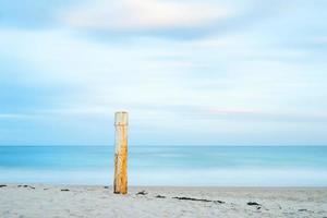 poteau en bois brun près du bord de mer pendant la journée photo