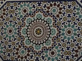 artisan marocain de la mosaïque peignant et décorant des produits céramiques dans une usine de poterie à fès, maroc photo