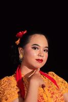 beau visage d'une femme asiatique aux lèvres rouges et maquillage en costume de danse traditionnelle indonésienne après le spectacle de danse photo