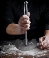 la main droite masculine tient un vieux couteau de cuisine en métal photo