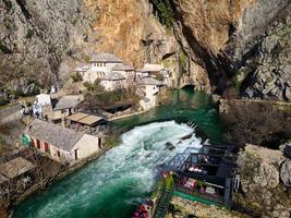 vue aérienne par drone de tekija à blagaj en bih. la tekija, la maison des derviches, située à la source de la rivière buna, était et est toujours un lieu où les derviches chantaient des louanges zikr trois nuits par semaine. photo