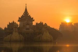 beau lever de soleil sur le palais de karaweik dans le canton de yangon au myanmar. photo