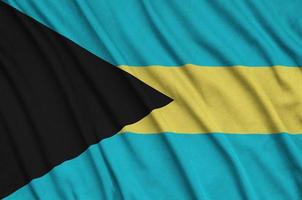 le drapeau des bahamas est représenté sur un tissu de sport avec de nombreux plis. bannière de l'équipe sportive photo
