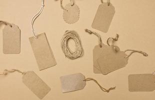 Vide marron rectangulaire, rond marron papier étiquette sur une corde isolé sur blanc arrière-plan, modèle pour prix, remise photo
