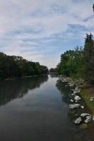 bleu ciels au dessus une rivière avec rive lignes photo