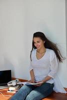 jeune femme détendue à la maison travaillant sur un ordinateur portable photo