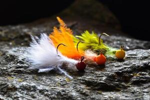 Groupe de banderoles jig colorées faites de plumes sur pierre grise photo