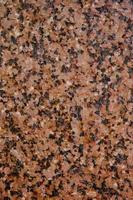 fond et texture pierre de granit avec inclusions noires. photo