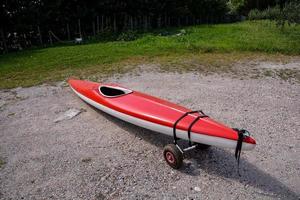 rouge kayak sur le rive photo