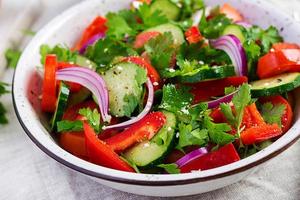 tomate et concombre salade avec rouge oignon, paprika, noir poivre et persil. végétalien aliments. régime menu.