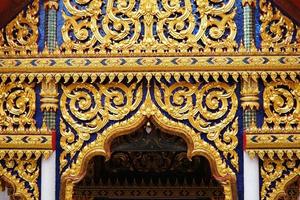 ancien d'or thaïlandais traditionnel sculpture dans de face de bouddhiste église. photo