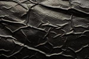 fond de texture de sac en plastique froissé et froissé noir photo