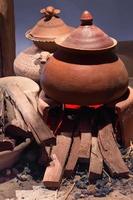 traditionnel poterie argile pot sur brique feu de camp avec Feu photo