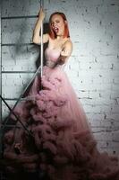 mignonne Jeune roux femme posant dans une studio photo