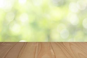 Table en bois avec fond d'herbe floue pour l'affichage photo