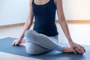 femmes sont Faire assise torsion des exercices pour santé et une plus ferme corps. yoga concept photo