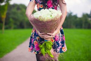 Jeune femme en portant une bouquet photo