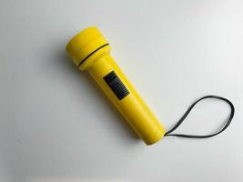 Jaune lampe de poche sur blanc Contexte. copie espace. lampe de poche pour coupure électrique et urgence. choisi concentrer photo