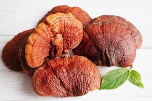 champignon lingzhi ou reishi avec capsules, aliments sains et naturels biologiques. photo