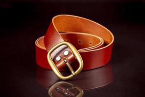 marron cuir ceinture sur une foncé Contexte. photo