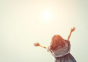 Jeune femme élever sa mains dans le ciel avec lever du soleil donc frais. photo