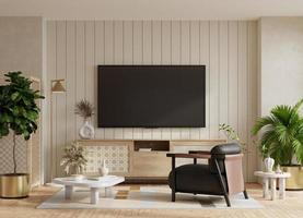 la télé et cabinet dans moderne vivant pièce avec cuir fauteuil et décoration dans chaud beige Contexte.